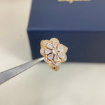 Gold openwork petal diamond ring with clear stones, side view