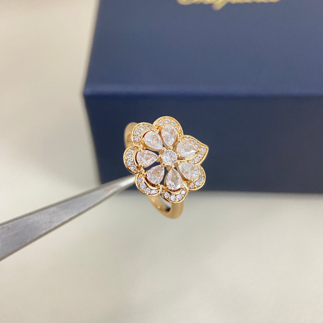 Gold openwork petal diamond ring with clear stones, side view