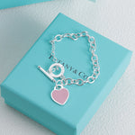 Silver bracelet with pink enamel heart charm and bar toggle clasp