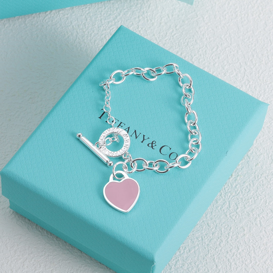 Silver bracelet with pink enamel heart charm and bar toggle clasp