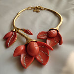 Coral red resin floral necklace with gold-tone chain and large petal centerpiece