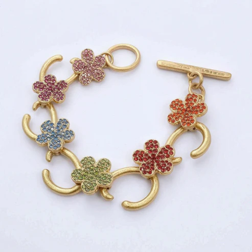 Gold-tone charm bracelet with multicolor flower pavé links and bar clasp