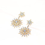 Blue crystal star stud and drop earrings, gold-tone eight-pointed star cluster details.