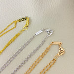 Set of heart pendant necklaces with diamond pavé hearts on gold and silver chains