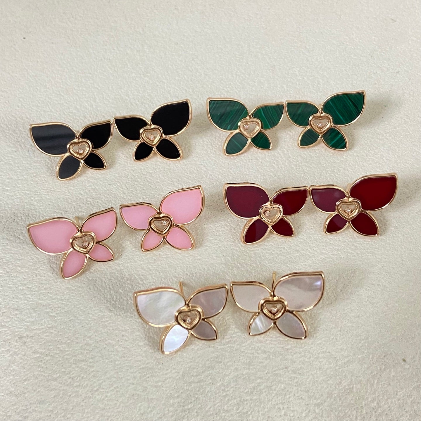 Enamel butterfly earrings, gold-tone with heart centers, assorted white, pink, red, green, black.
