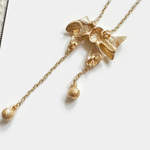 Vintage bow crystal tassel necklace with gold-tone chain and dangling charm drops