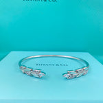 White gold-tone open leaf bangle with diamond-encrusted leaf details