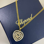 Heart pendant necklace with diamond pavé triple-heart design on a gold chain