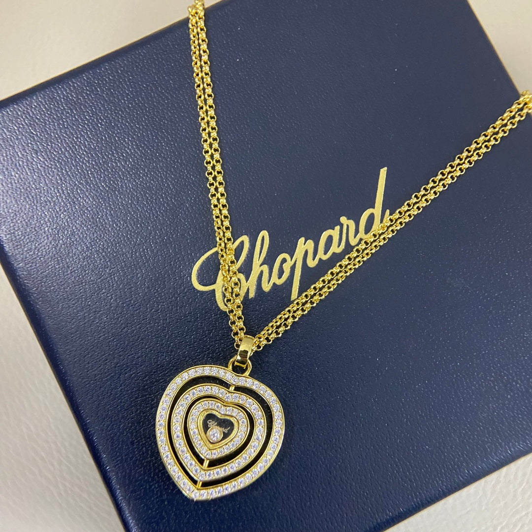 Heart pendant necklace with diamond pavé triple-heart design on a gold chain