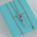 White gold pavé knot key pendant necklace with linked chain and key charm