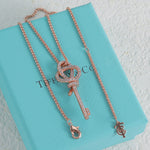 Rose gold pavé knot key pendant necklace with linked chain and key charm