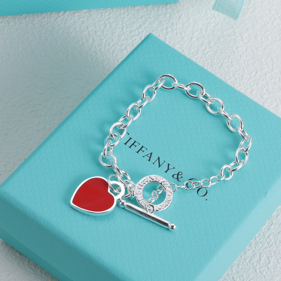 Silver bracelet with red enamel heart charm and bar toggle clasp