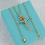Gold pavé knot key pendant necklace with linked chain and small key charm