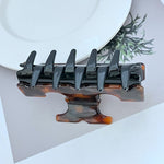 Shark T-shaped hair clip, black with warm amber underside