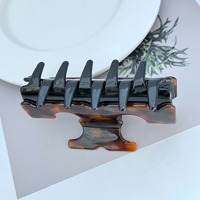 Shark T-shaped hair clip, black with warm amber underside