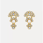 Crystal arched fan-layered stud earrings, white stones with gold-tone settings