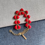 Heart-shaped necklace with red enamel heart charms and gold chain clasp