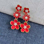 Enamel plum blossom drop earrings, red blossoms with pearl centers and gold-tone outlines