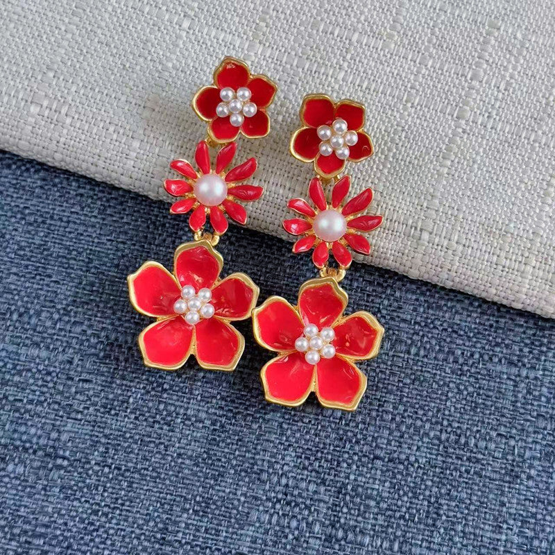 Enamel plum blossom drop earrings, red blossoms with pearl centers and gold-tone outlines