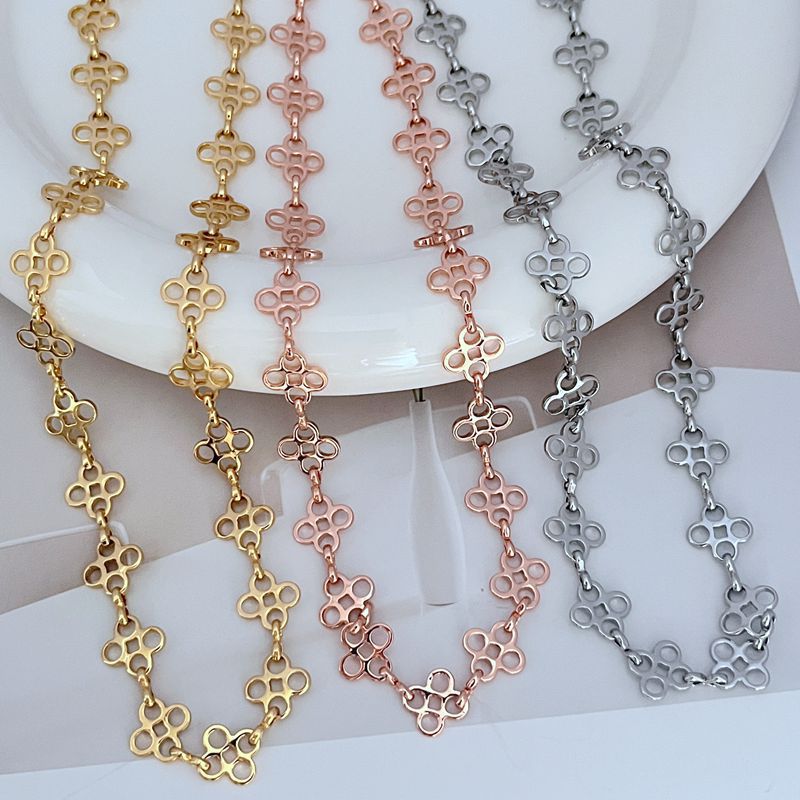 Multi-tone clover link sweater chain set in gold, rose gold, and silver