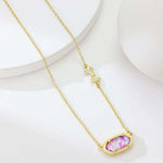 Purple rose-print oval pendant with bow charm on gold chain