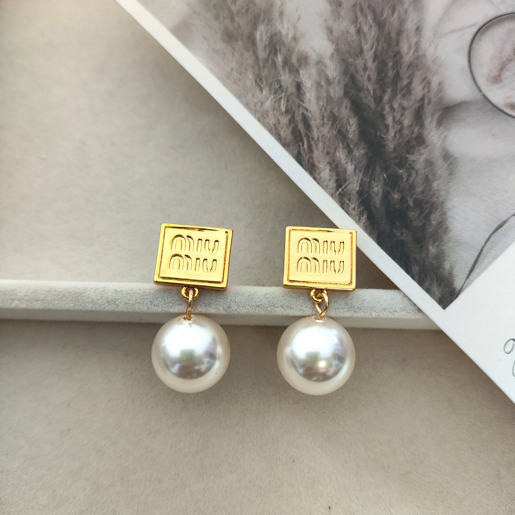Miu Miu gold square tag earrings with white pearl dangles