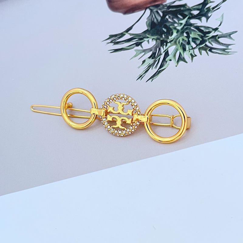 Gold round metal hair clip with double rings and jeweled center