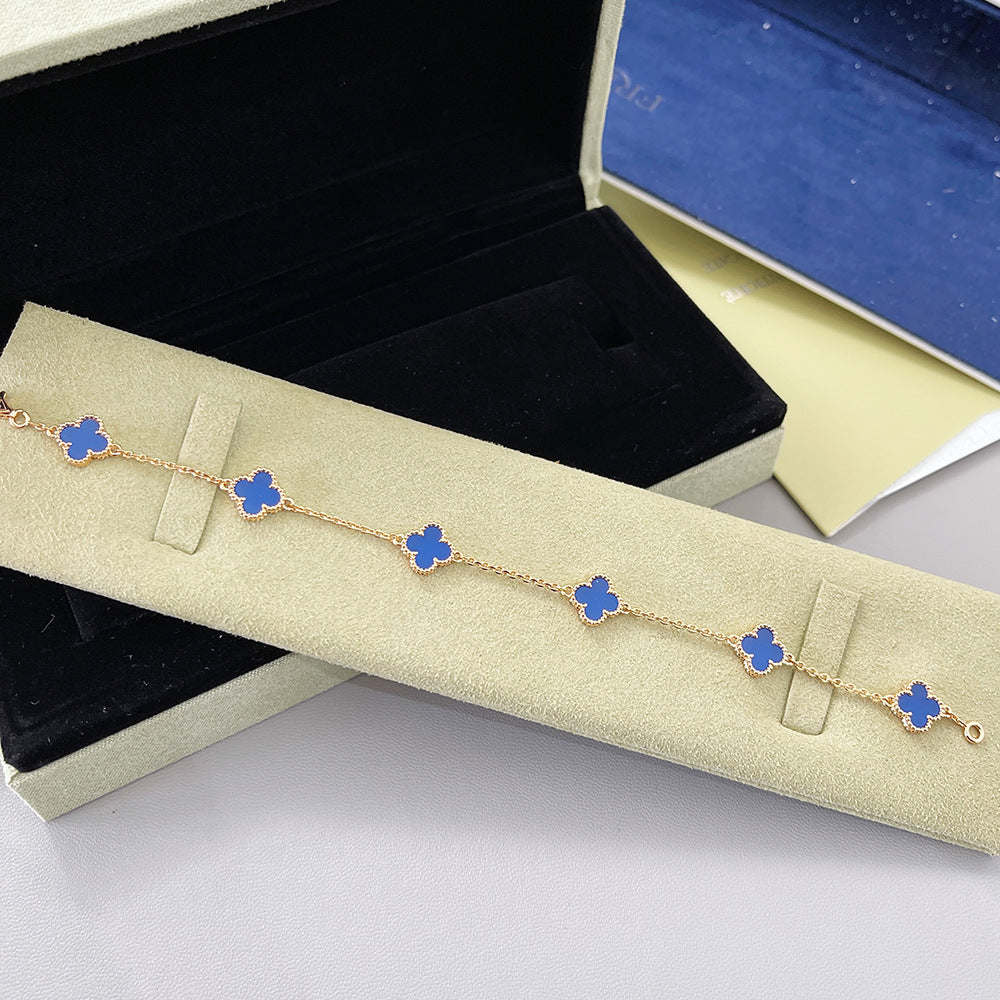Gold tone bracelet with blue clover charms on a fine chain