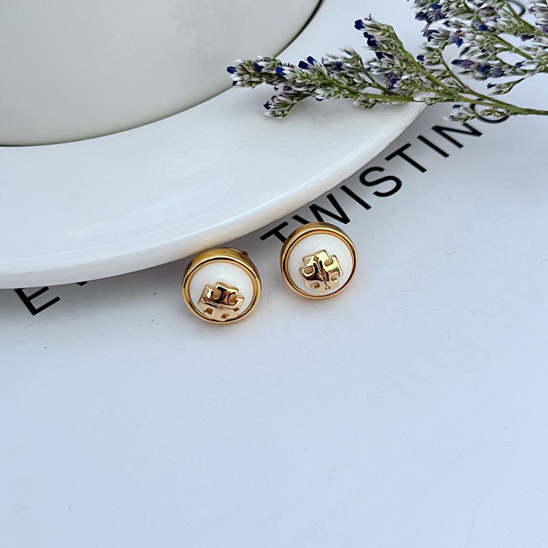 Round logo resin stud earrings, white resin discs with gold-tone bezel