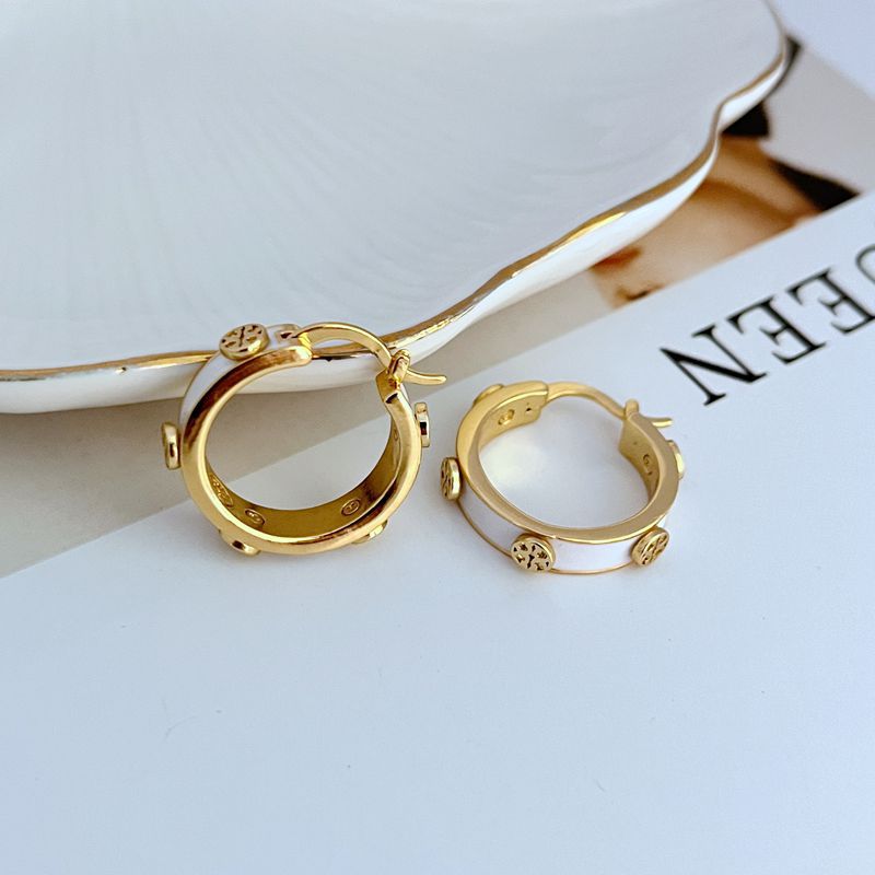 Tory Burch enamel logo hoop earrings, gold-tone with white enamel and logo charm details