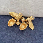 Gold-tone clip-on earrings with strawberry and leaf charms, pearl clusters, and crystal sparkle