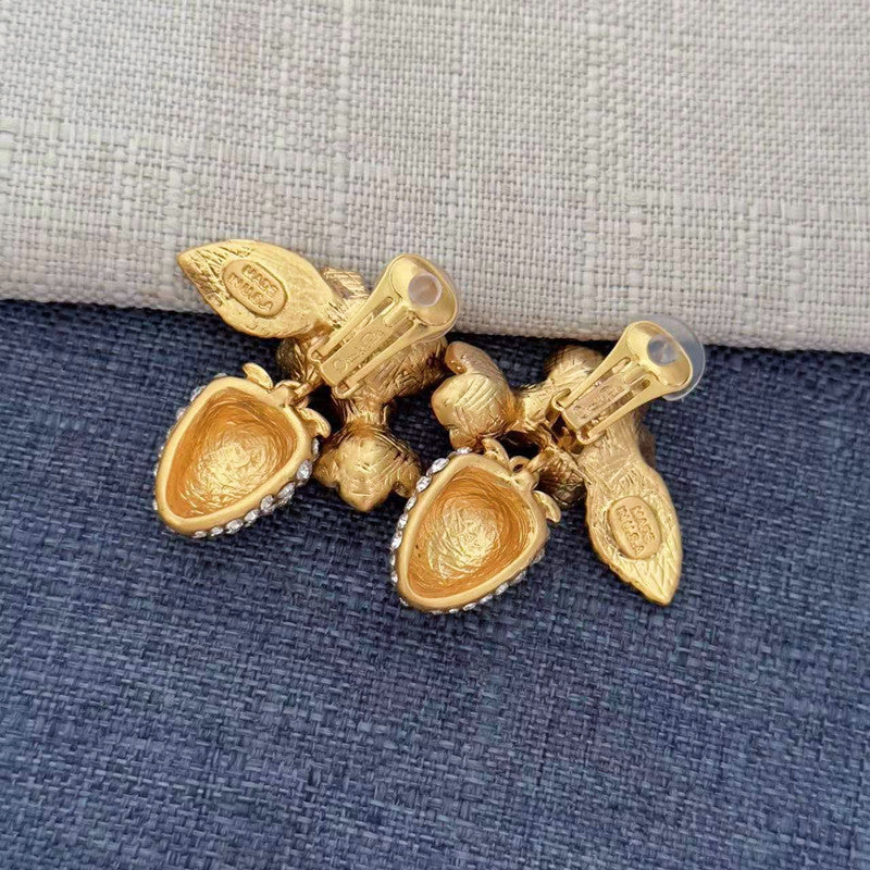 Gold-tone clip-on earrings with strawberry and leaf charms, pearl clusters, and crystal sparkle
