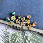 Four-leaf clover earrings with mixed stones: green, clear/gray, and champagne with gold-tone settings