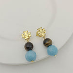 Gold logo pendant earrings with dark and light blue agate beads, drop style
