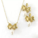 Bow pendant necklace with white pearl drop, paired with matching stud earrings