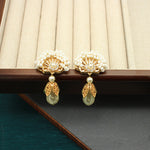 Pair of fan-shaped pearl earrings with gold crown centers and teardrop pearl drops