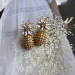 White enamel flower diamond earrings with gold textured pineapple drops and crystal center