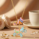 Enamel rocking horse necklace with gold chain, blue horse charm and multicolor teacup charms