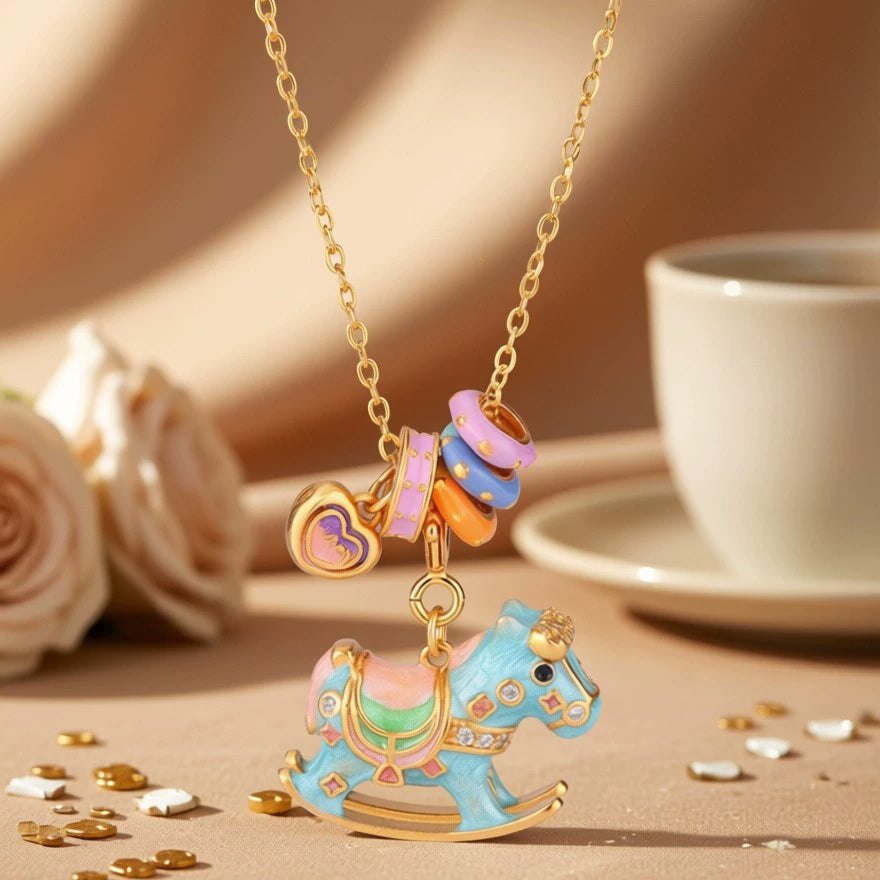 Enamel rocking horse necklace with gold chain, blue horse charm and multicolor teacup charms