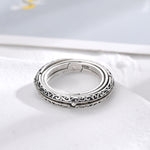 Silver engraved ring band with filigree details and open circular inner frame