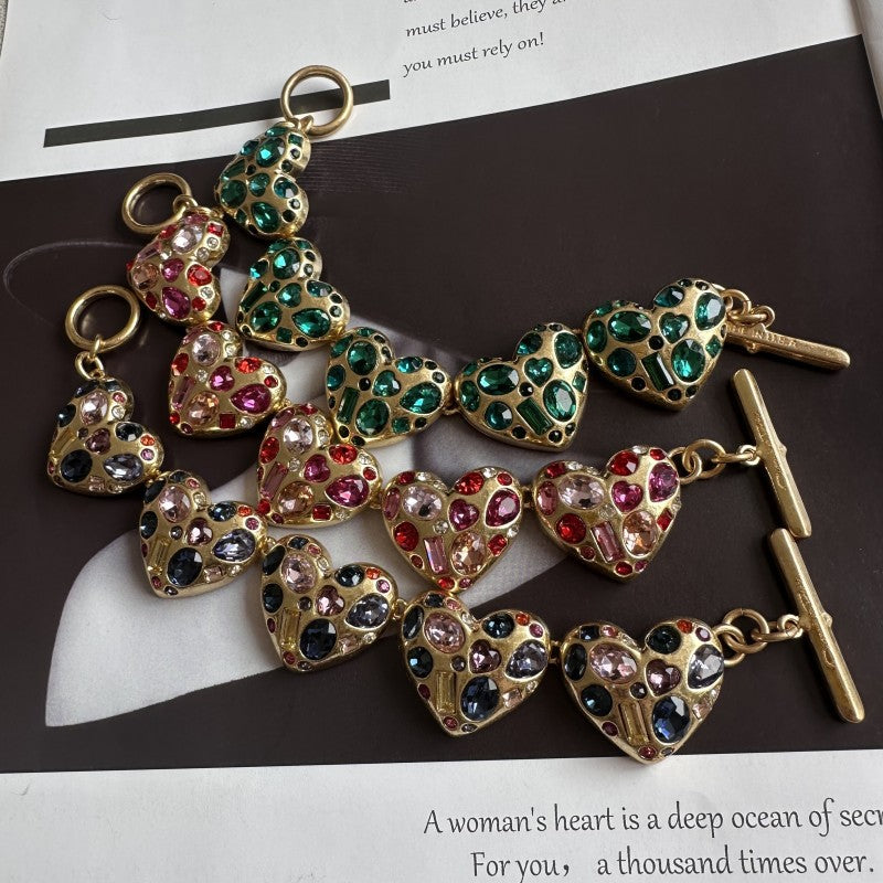 Heart bracelet with pink and green gemstone heart charms, gold-tone chain links