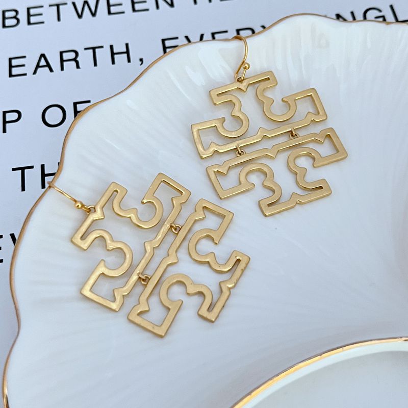 Gold openwork logo earrings, large geometric drops with linked bar detail