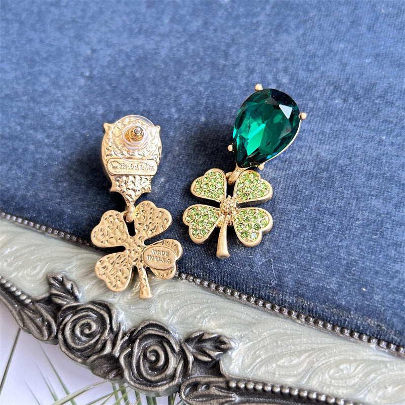 Gold-tone four-leaf clover earrings with emerald-green teardrop stones and green pavé centers