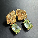 Gold-tone crystal drop earrings with green oval stones