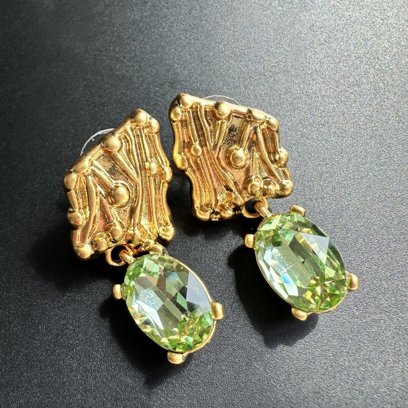 Gold-tone crystal drop earrings with green oval stones