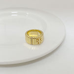 Gold metal ring with vertical striped band and rhinestone accents