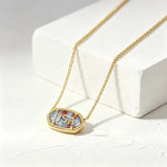 Gold-tone oval USA letter pendant necklace with blue enamel border