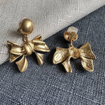 Gold-tone bow drop earrings with clasp backs and textured bow charms