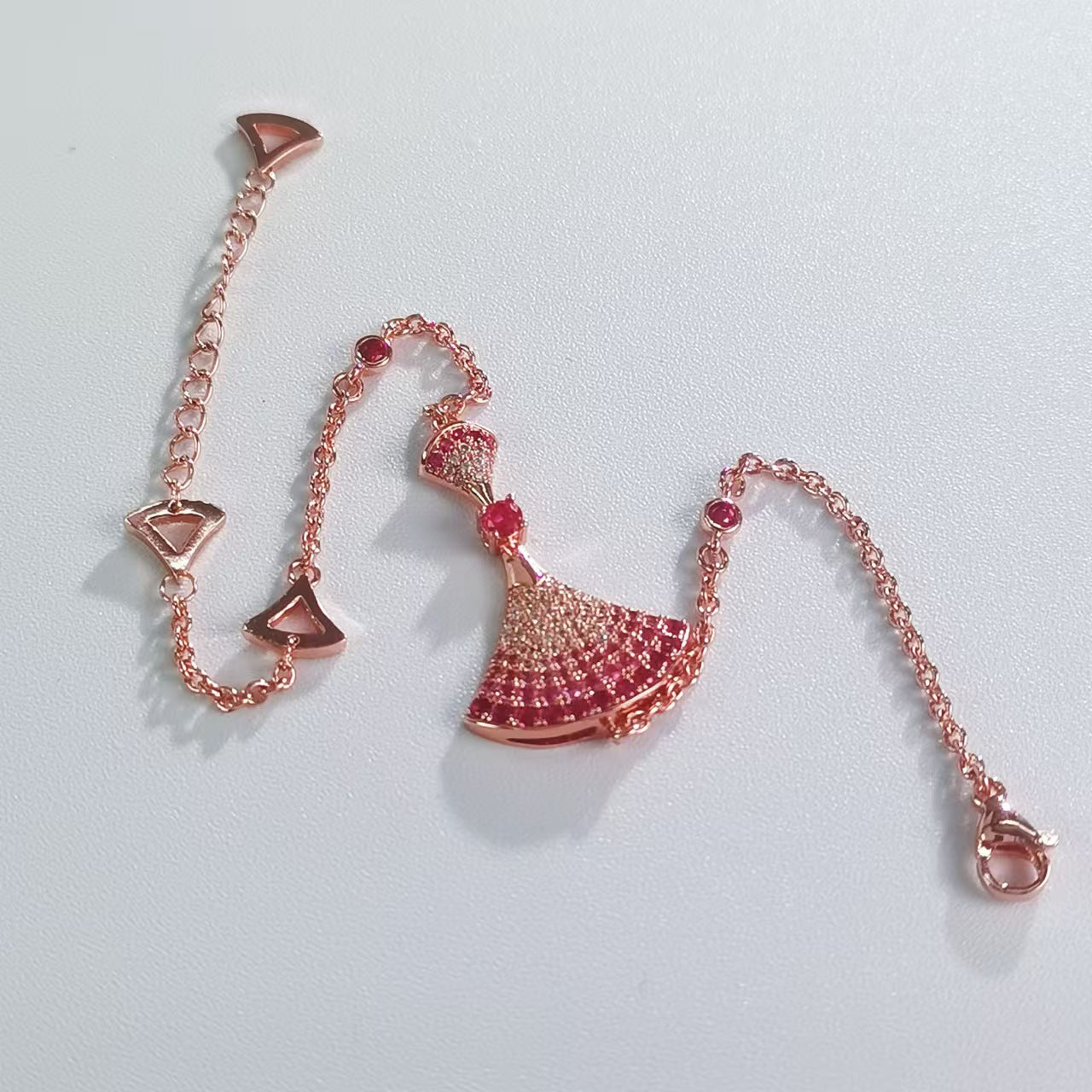 Rose gold rhinestone fan-shaped bracelet laid out with end links and fan charm