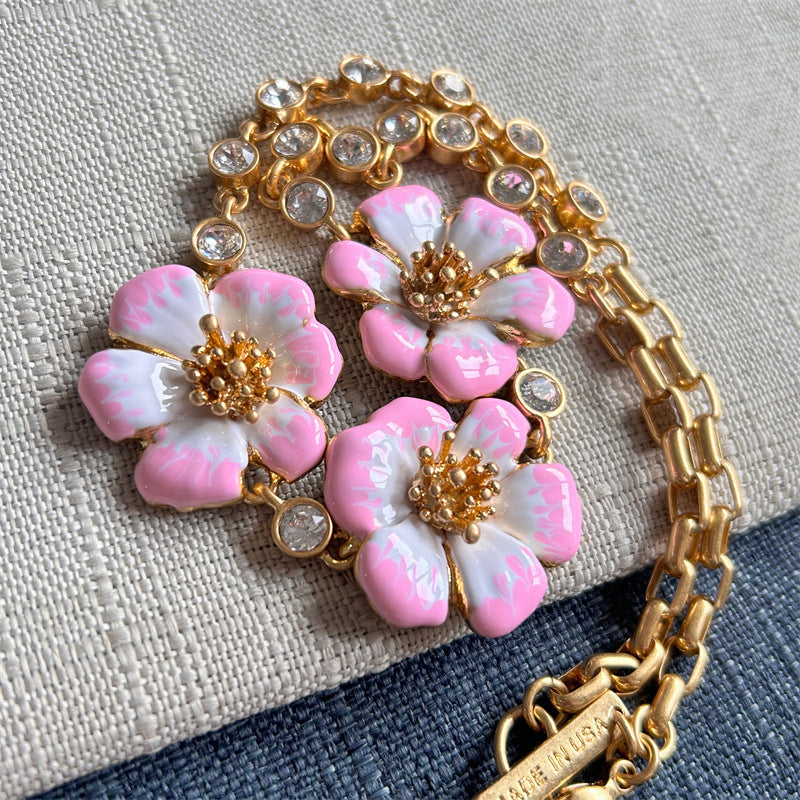 Enamel cherry blossom pendant necklace with pink and white flowers, gold chain and clear stones